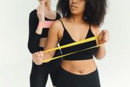 Resistance band hand workout (Image via Pexels/Polina Tankilevitch)